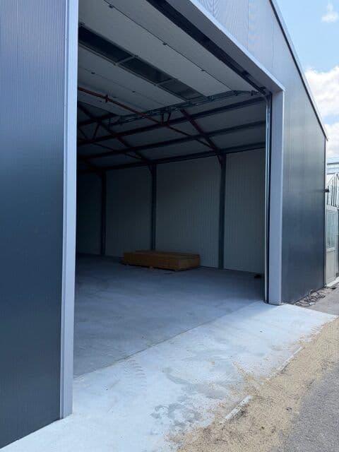 De geopende overheaddeur met de nieuwe betonvloer